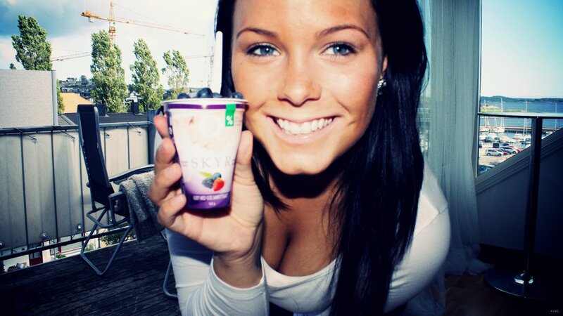 woman holding yogurt on balcony