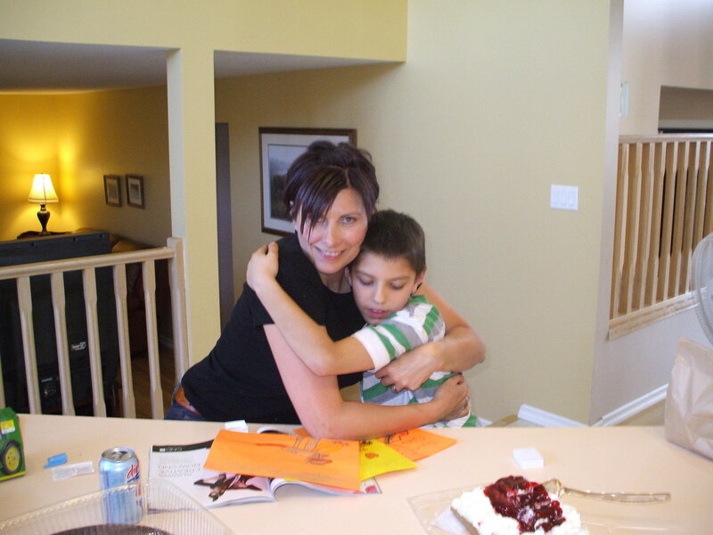 woman hugging a boy at home