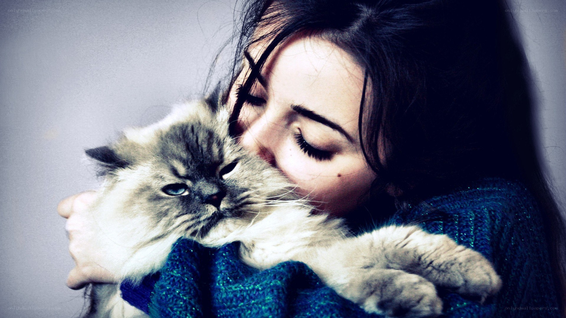 woman hugging a cat