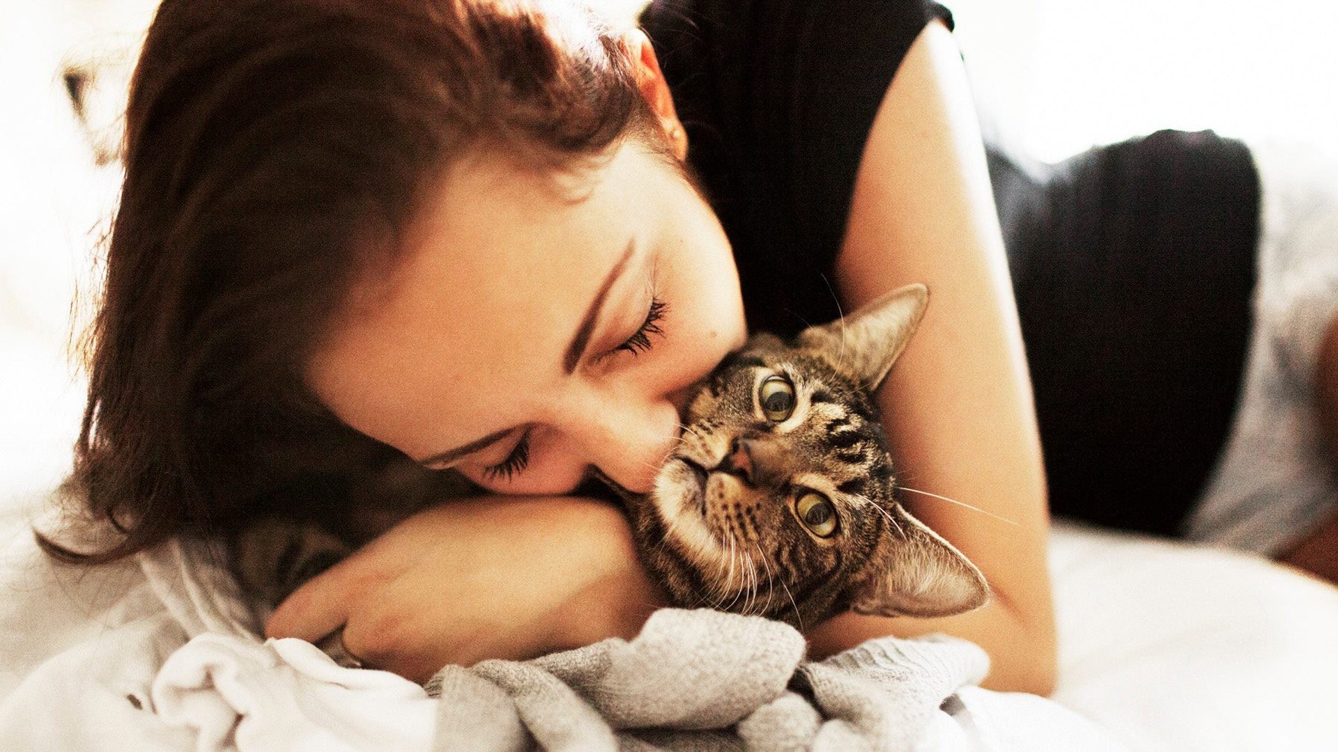 woman hugging a cat