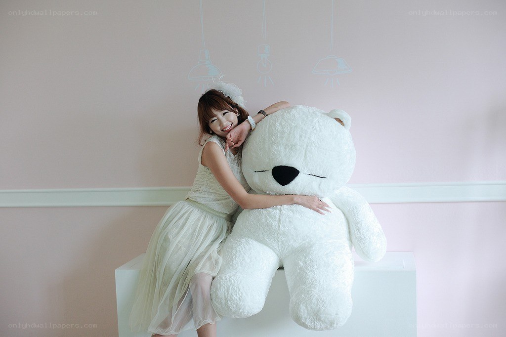 Woman hugging a large teddy bear