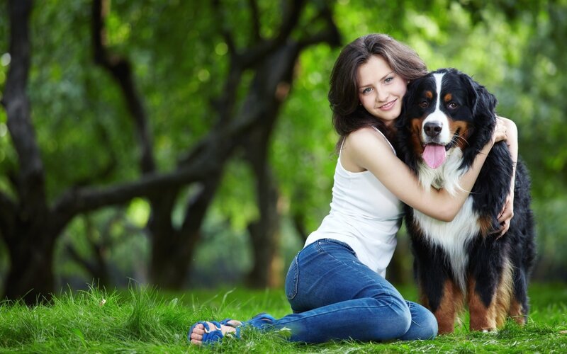 Woman hugging dog in park