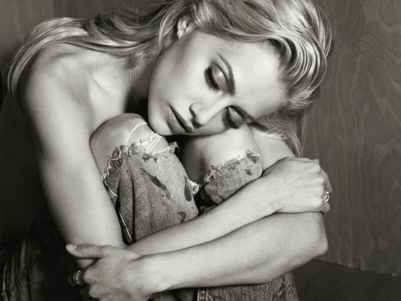 woman hugging herself in black and white