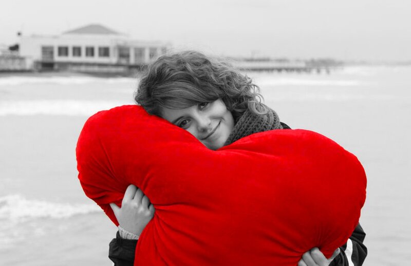 Woman Hugging Red Pillow
