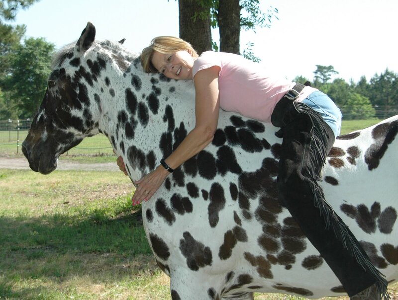 Woman Hugging Spotted Horse