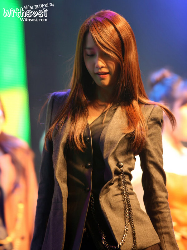 woman in a blazer on stage