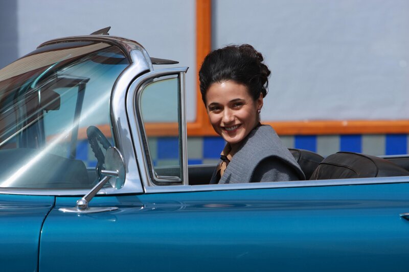 Woman in a blue convertible car