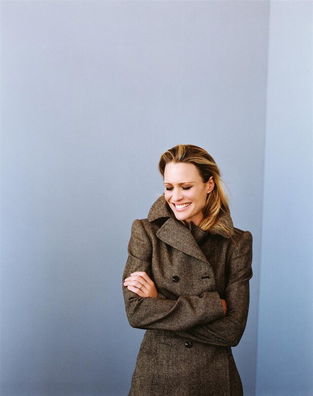 woman in a brown coat smiling