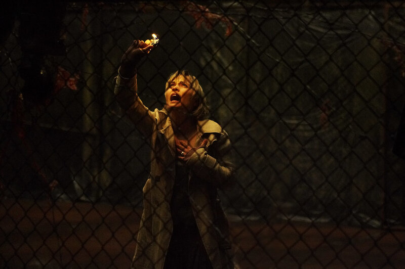 Woman in a cage with a lighter