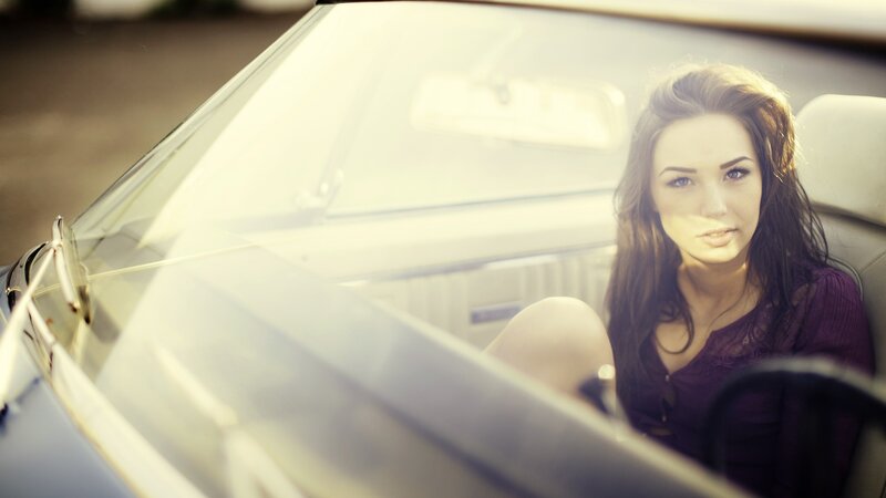 woman in a car at sunset