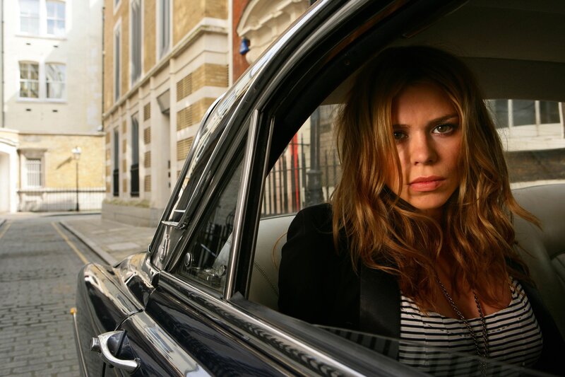 woman in a car on a city street