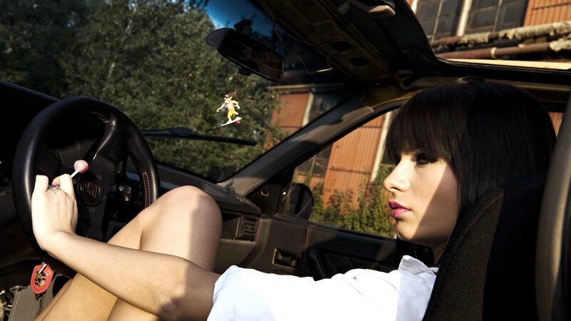 Woman in a car with lollipop