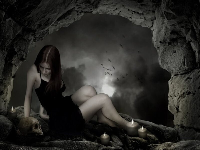 woman in a cave with candles