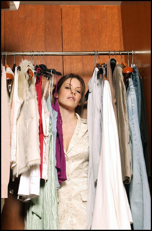 woman in a closet with clothes