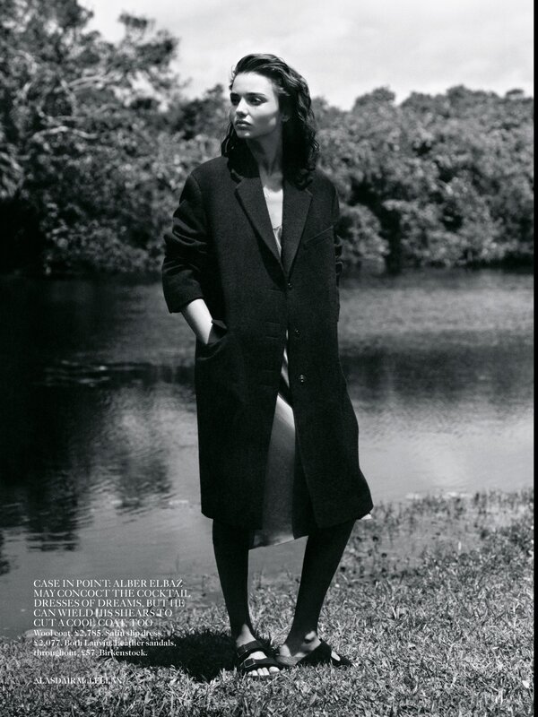 Woman in a coat by the water