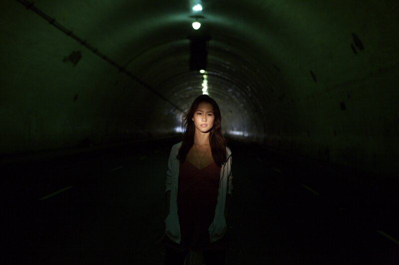 woman in a dark tunnel