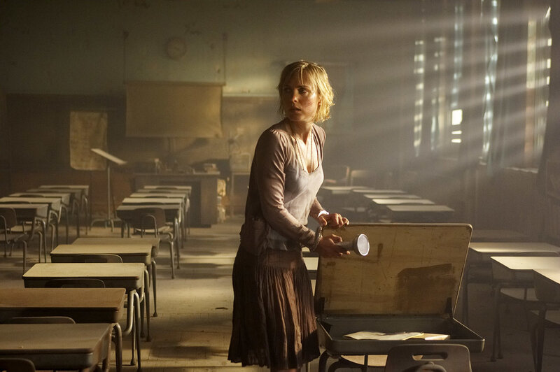 Woman in a dimly lit classroom