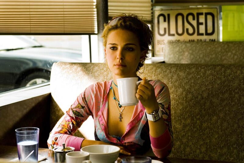Woman in a diner holding coffee