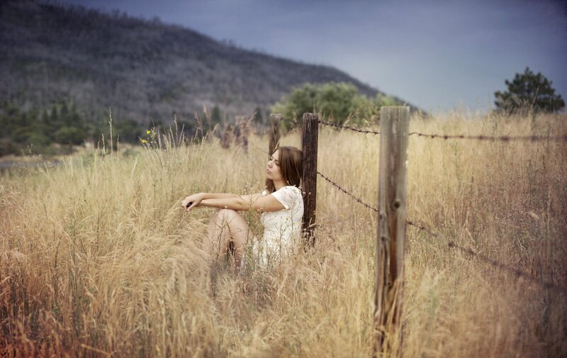 Woman in a field at dusk