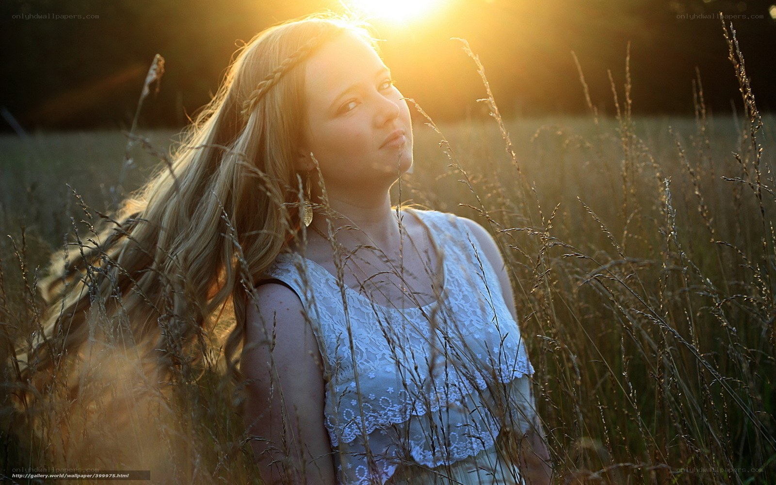 Woman in a field at sunset