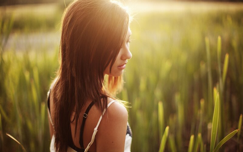 woman in a field at sunset