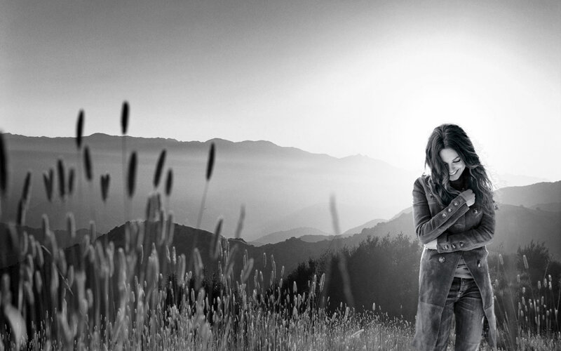 woman in a field at sunset