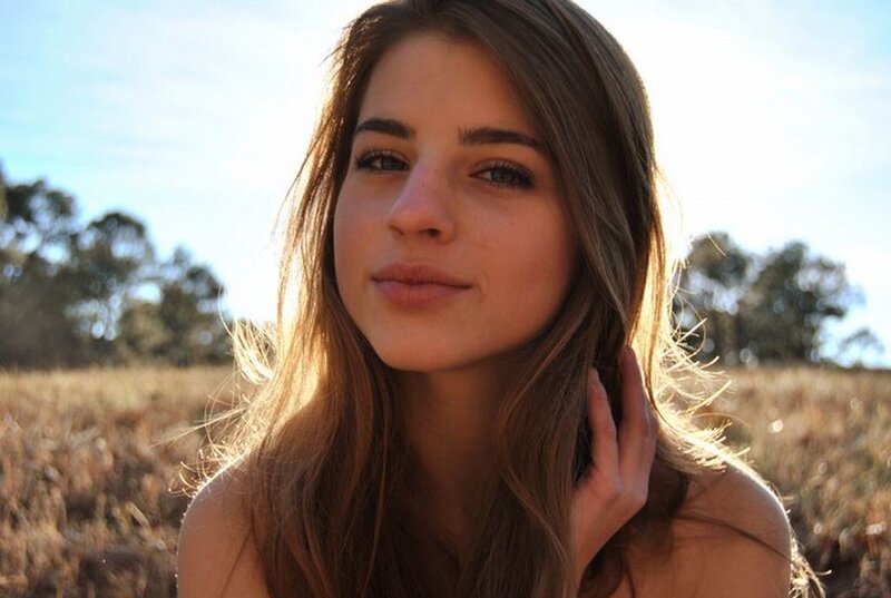 woman in a field at sunset