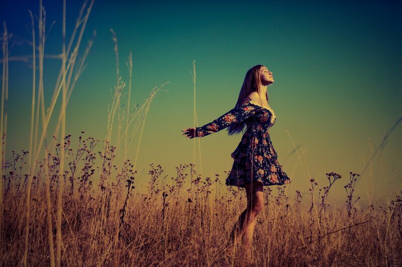 Woman in a field at sunset