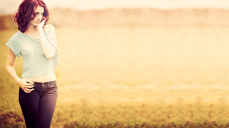 woman in a field at sunset