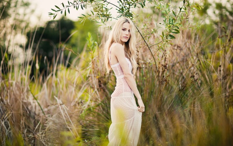 Woman in a field at sunset