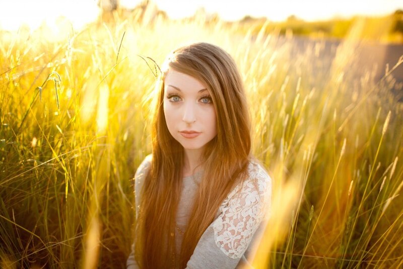 woman in a field at sunset