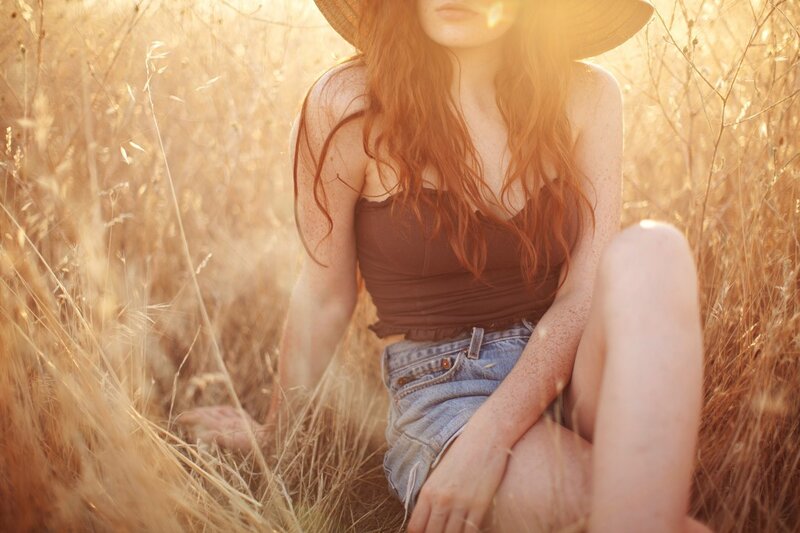 Woman in a field at sunset
