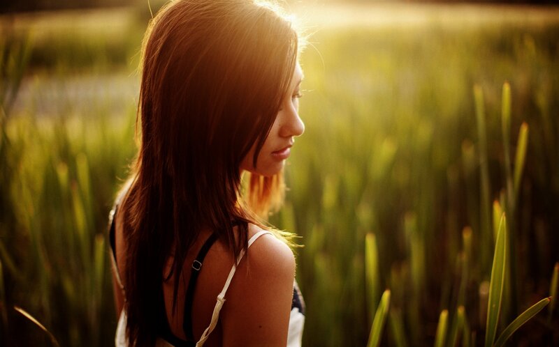 woman in a field at sunset