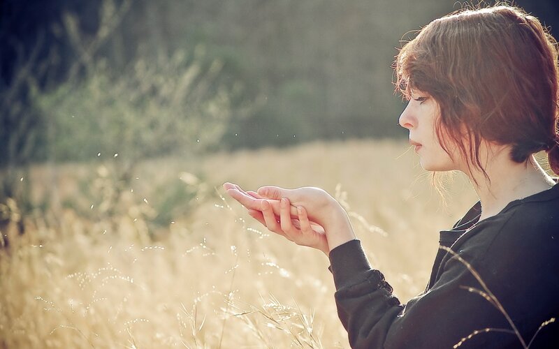 woman in a field at sunset