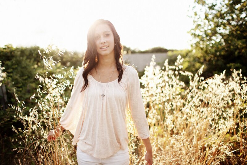woman in a field at sunset