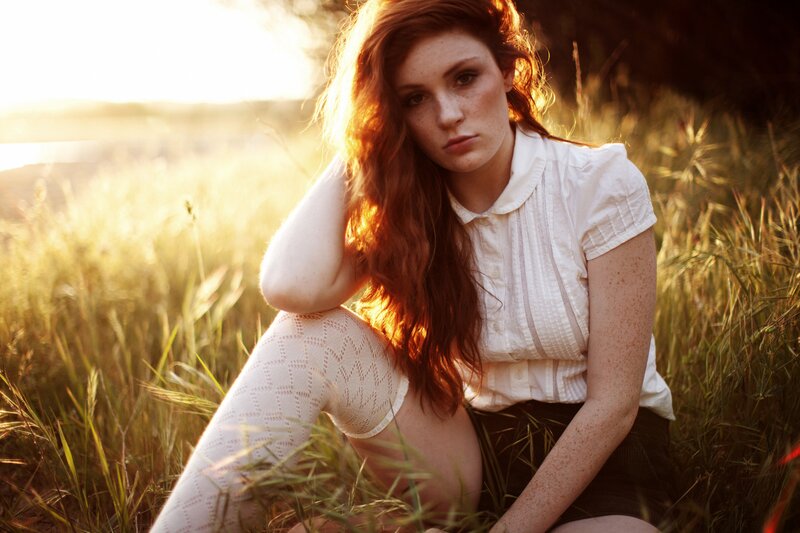 woman in a field at sunset