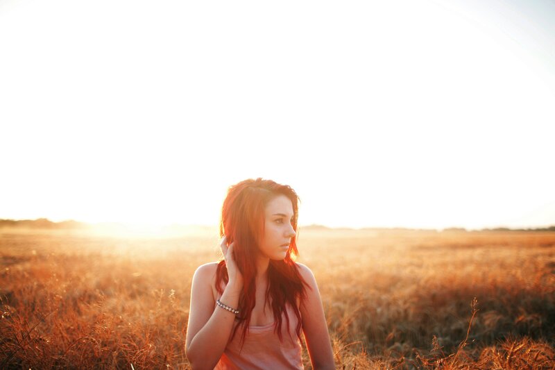 woman in a field at sunset