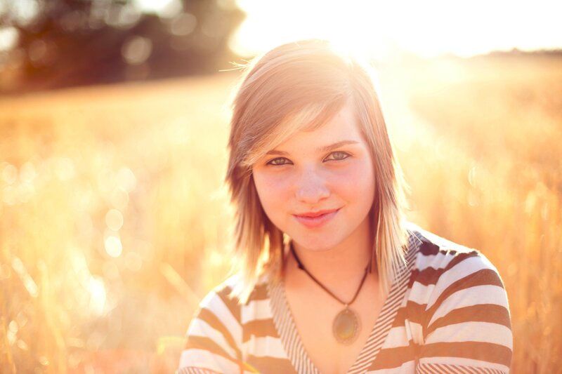 woman in a field at sunset