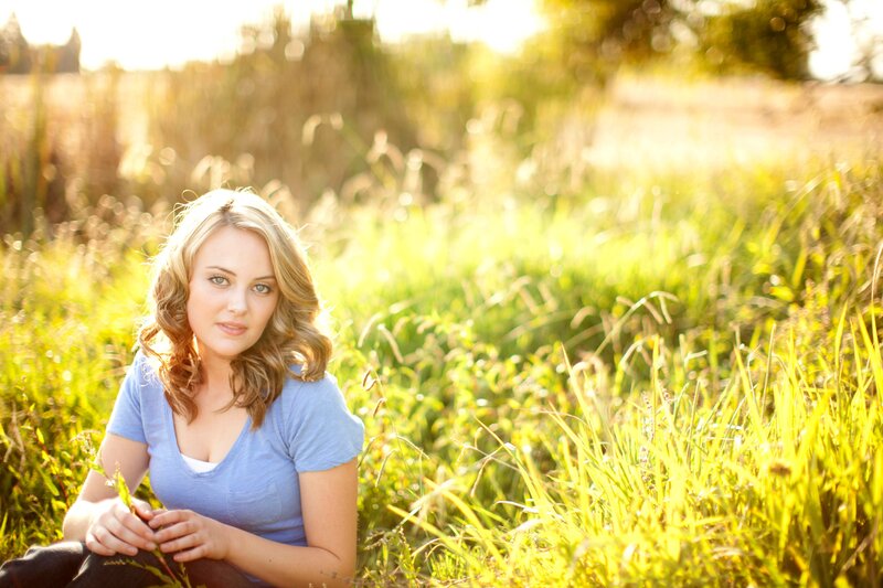 woman in a field at sunset