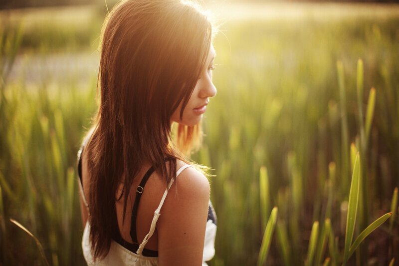 woman in a field at sunset