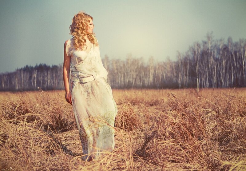 Woman in a field at sunset
