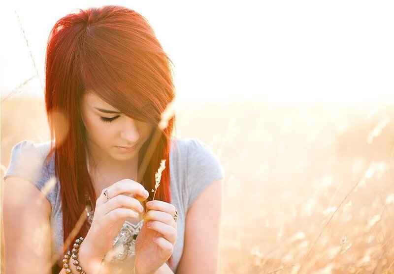 woman in a field at sunset