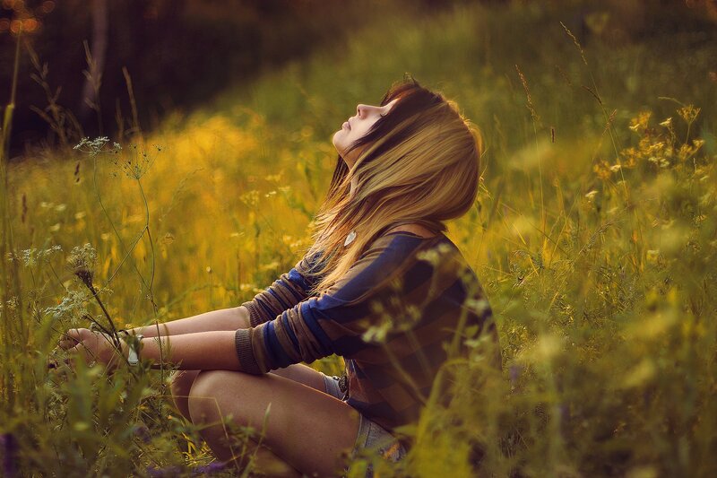 woman in a field at sunset