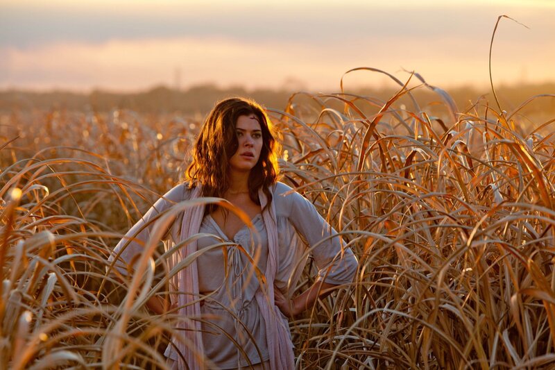 woman in a field at sunset