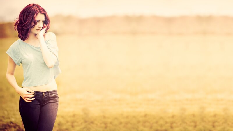 woman in a field at sunset