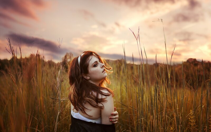woman in a field at sunset