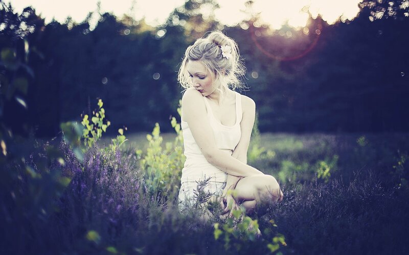 woman in a field at sunset