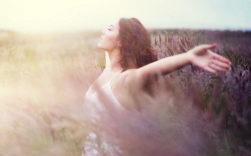 woman in a field at sunset