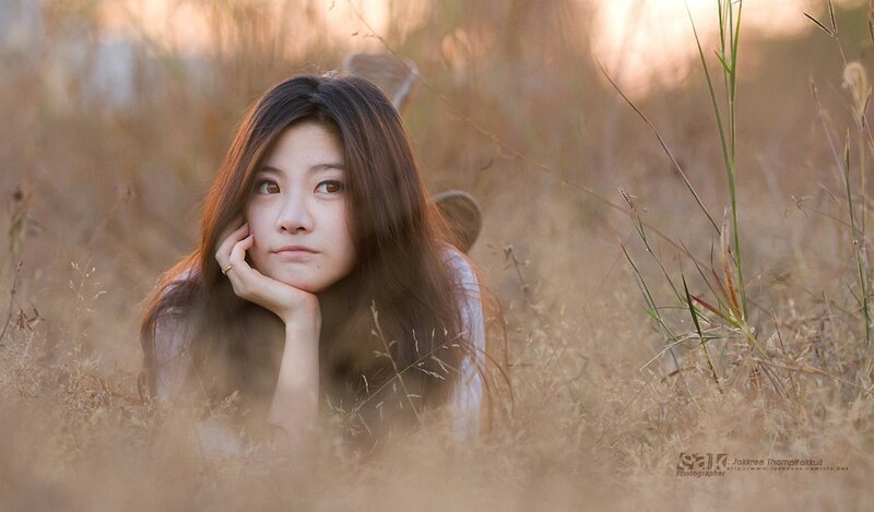 woman in a field at sunset