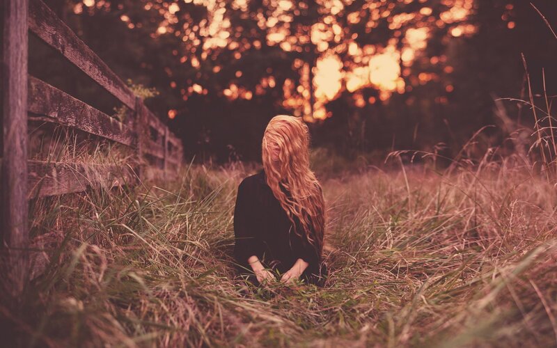 woman in a field at sunset